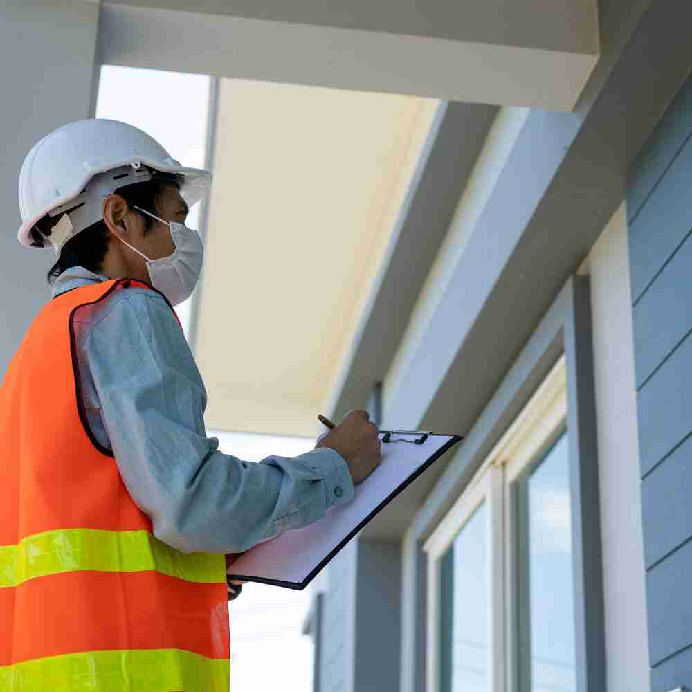 Construction inspector evaluating a building exterior.